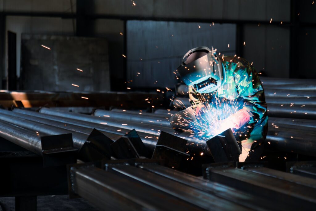 Industrial welder welding metal profiles